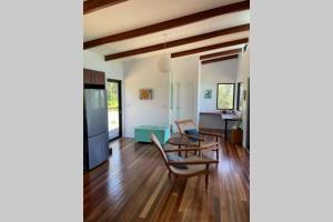 a living room with chairs and a table at Ridge Cabin - Stunning Views - 5km From Neighbours in Airlie Beach