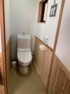 a small bathroom with a toilet and a window at Munetada House in Kyoto +21 photos