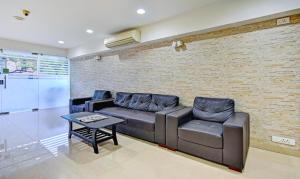 a living room with a couch and a coffee table at Treebo Trend Vapr Guindy Ekkatuthangal in Chennai