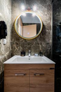 a bathroom with a sink and a mirror at Novelrooms in Paralia Katerinis