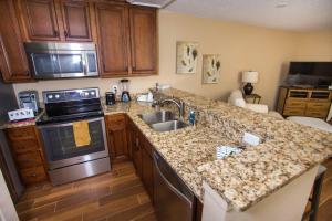 a kitchen with a sink and a stove top oven at Lakeside 312 at Bluewater Bay Resort in Niceville