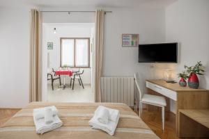 a living room with a table and a dining room at Apartments Villa Katana in Poreč