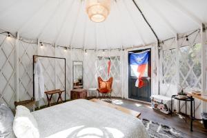 a bedroom with a bed in a tent at Lucky Arrow Retreat in Dripping Springs +40 photos