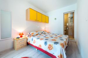 a bedroom with a bed and a dresser and a window at Guest House Kuna in Dubrovnik
