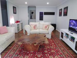 a living room with a couch and a coffee table at Keillor Lodge in Maleny