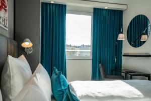 A bed or beds in a room at Motel One Berlin Mitte