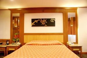 Ein Bett oder Betten in einem Zimmer der Unterkunft Royal Twins Palace Hotel