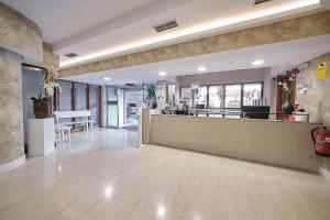 a lobby of a restaurant with a counter at Hotel Faro Salazón in Sanxenxo