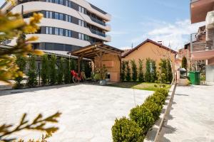 a patio in front of a tall building at Villa Misija in Ohrid