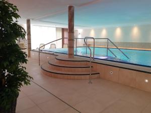 a swimming pool with a slide in a building at Gästehaus Schlossbräu in Autenried