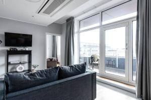 a living room filled with furniture and a window at Biz Apartment Gärdet in Stockholm
