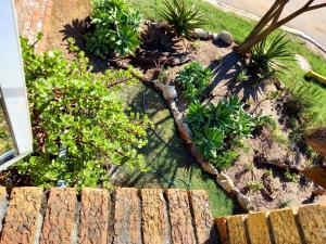 an aerial view of a garden with plants and a fence at Mond Kleine Guest House in Kleinmond