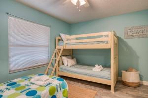 a bedroom with two bunk beds in a room at Driftwood Escape in Butler Beach +42 photos