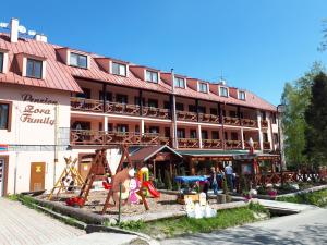 a large building with a playground in front of it at Apartmán ZORA Family in Tatranská Lomnica