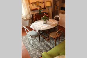 a dining room with a table and chairs and a kitchen at Antiche Fonti in Bibbona +31 photos