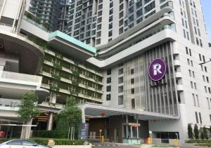 a large building with a purple parking sign on it at Robertson PanoramaKL Suites in Kuala Lumpur