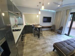 a kitchen and living room with a table and chairs at Guest house on Gillian Unit 1 in Ballito