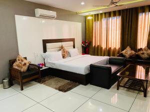 a hotel room with a bed and a couch at Mithilesh Hotel in Kaithal