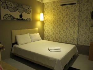 a bedroom with a bed with two towels on it at 7 Star Hotel in Kota Damansara