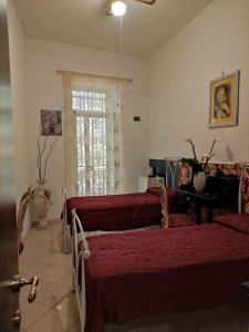 sypialnia z 2 łóżkami i oknem w obiekcie Little Anema & Core w mieście Castellammare di Stabia