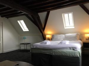 
a bedroom with a bed and a window at Uylenhof Hotel in Den Bosch
