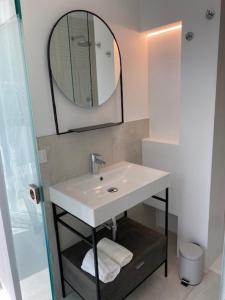 a bathroom with a sink and a mirror at Velar Apartment Suites in Lignano Sabbiadoro +30 photos