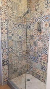 a bathroom with a shower with tiles on the wall at Enjoy Oporto Flats in Porto