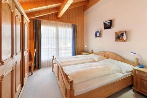 A bed or beds in a room at Serviced Apartments – Kirchbühl@home