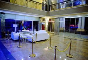 a lobby with a white couch and a desk in a building at Room in Lodge - Hampton Towers Spa in Asaba