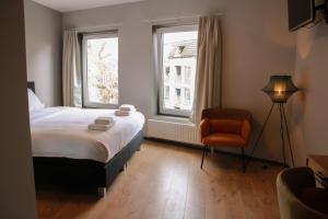 Postel nebo postele na pokoji v ubytování HOLT Hotel