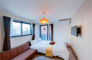 a hotel room with a bed and a couch at japan house sky tree in Tokyo
