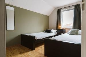 a room with two beds and a window at Mosselbank 81 - Noordzeepark Ouddorp - not for companies in Ouddorp