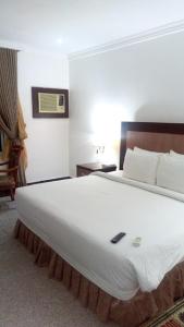 Posteľ alebo postele v izbe v ubytovaní Room in BB - Immaculate Royal International Hotel