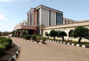 a building with a brick walkway in front of a building at Room in Lodge - Nelrose Hotel, Asaba in Asaba
