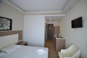 a hotel room with a bed and a sink at Sevastos Studios in Faliraki