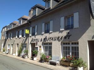 a building with a sign on the side of it at Hotel des Voyageurs in Tarnac