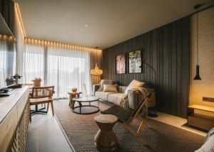 a living room with a couch and a table at Les Cabanes de l'Oller del Mas in Manresa