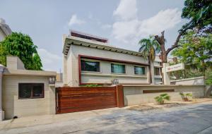 a house with a wooden gate on a street at La Sagrita in New Delhi