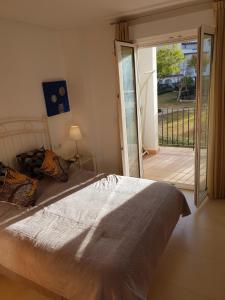 a bedroom with a bed and a door to a balcony at Casa Bacaladilla - A Murcia Holiday Rentals Property in Roldán