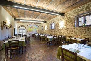 a restaurant with tables and chairs in a room at Agriturismo San Galgano in Chiusdino