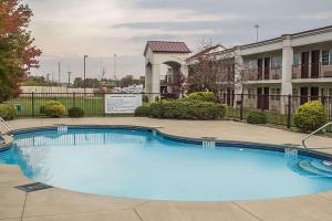 a large blue swimming pool in front of a building at Days Inn by Wyndham Austintown in Austintown