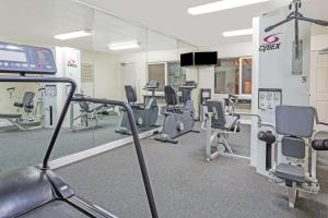 a gym with a lot of chairs and a mirror at Days Inn by Wyndham Novato/San Francisco in Novato