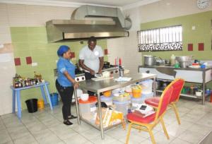 A kitchen or kitchenette at Room in Lodge - Wetland Hotels, Ibadan