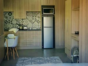 a kitchen with a refrigerator with a microwave above it at Rand Self-catering Accommodation in Carolina