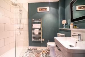 a bathroom with a shower and a toilet and a sink at 15 Stonegate Court in York