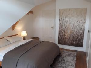 a bedroom with a bed and a painting on the wall at Apartment Schreyegg in Seefeld