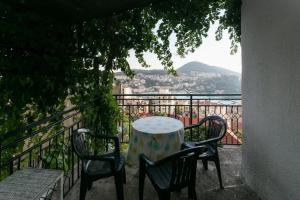 una mesa y sillas en un balcón con vistas en Guest House Barbara, en Dubrovnik