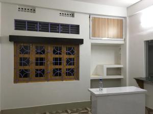 a kitchen with a stained glass window on the wall at Vamoose S Das Homestay in Agartala