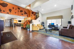 a living room with a couch and a table at Sleep Inn Leesburg Chain of Lakes in Leesburg