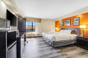 a hotel room with a bed and a television at Sleep Inn Leesburg Chain of Lakes in Leesburg +16 photos